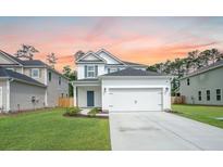 Charming two-story home featuring a two-car garage and well-maintained lawn at 224 Wappoo Trace Ln, Summerville, SC 29486