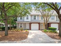 Charming townhome featuring attached garages and brick accents at 241 Kelsey Blvd, Wando, SC 29492