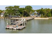 Waterfront home featuring a private boat dock, covered boat lift, and deck space for enjoying the serene views at 2619 Buccaneer Rd, Isle of Palms, SC 29451
