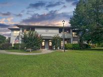 Charming two-story home featuring a well-manicured lawn and a welcoming entrance, complemented by lush greenery at 3104 Mariners Way, Moncks Corner, SC 29461