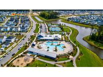 An aerial view showcasing the community amenities, including a pool, tennis courts, and lake at 312 Clearpath Dr, Summerville, SC 29486
