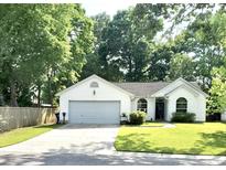Charming single-story home with a manicured lawn and attached two-car garage at 3415 Pawtucket St, Charleston, SC 29414