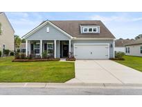 Charming one-story home features a gray exterior, landscaped yard, and a two-car garage at 3431 Great Egret Dr, Johns Island, SC 29455