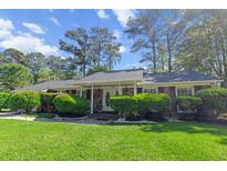 Charming single-story home with a well-maintained front yard and covered porch at 411 Dogwood Circle, Summerville, SC 29485