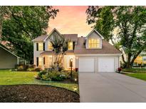 Charming home featuring a landscaped yard, two-car garage, and inviting front porch at 448 Jardinere Walk, Mount Pleasant, SC 29464