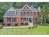 Charming brick home with a welcoming front porch and beautifully landscaped yard at 1200 Out Of Bounds Dr, Summerville, SC 29485