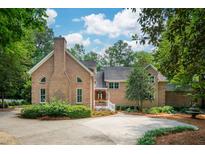 Stunning brick home featuring lush landscaping and a circular driveway at 125 Drayton Dr, Summerville, SC 29483