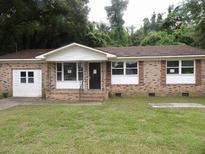 Charming brick single-story home with a well-maintained front yard and inviting entrance at 1277 Russellville Rd, Saint Stephen, SC 29479
