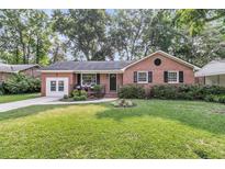 Charming brick home featuring a beautifully landscaped front yard and inviting entrance at 1391 Fairfield Ave, Charleston, SC 29407