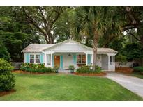 Charming home featuring turquoise shutters, a landscaped yard, and a welcoming front porch at 1408 Goblet Ave, Mount Pleasant, SC 29464