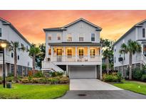 Two-story home with white siding, charming front porch, and well-maintained landscaping with palms at sunset at 1494 N Lakeshore Dr, Mount Pleasant, SC 29466