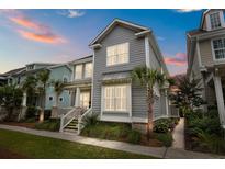 Charming two-story home boasts manicured landscaping, a welcoming porch, and classic architectural details at 1557 Kepley Dr, Mount Pleasant, SC 29464