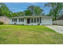 Charming ranch-style home with a manicured lawn and attached garage in a desirable neighborhood at 1917 Piper Dr, Charleston, SC 29407