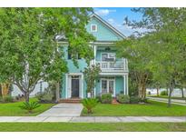 Charming two-story home with a porch, balcony, well-maintained lawn and lush landscaping at 300 Foxglove Ave, Summerville, SC 29483