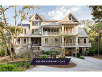 Stunning multi-story home featuring covered balconies and meticulous landscaping, inviting outdoor living at 34 Eugenia Ave # B, Kiawah Island, SC 29455