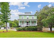 Charming two-story home with a welcoming front porch and a lush green lawn at 3636 Purple Martin Ct, Mount Pleasant, SC 29466
