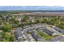 A beautiful aerial shot shows well-manicured lawns, colorful townhomes, and views of the marsh at 7787 Montview Rd, North Charleston, SC 29418