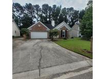 Charming one-story brick home with a well-manicured lawn and an attached two-car garage at 8420 Walsham St, North Charleston, SC 29420