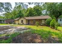 Charming single story home featuring mixed siding and a lush, landscaped front yard at 1004 Miles Jamison Rd, Summerville, SC 29485