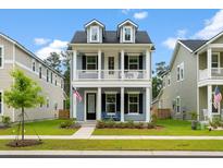 Charming two-story home with a welcoming porch and a beautifully landscaped front yard at 113 Osprey Ridge Ln, Summerville, SC 29483