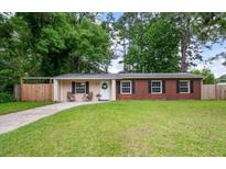 Charming single-story home featuring a well-maintained lawn, brick accents and a welcoming front entrance at 14 Aldene Ave, Goose Creek, SC 29445