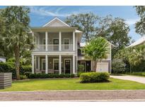 Charming two-story home with a double porch, lush landscaping, and a well-manicured lawn at 1405 Mataoka St, Mount Pleasant, SC 29464