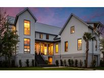 Stunning two-story home featuring a manicured lawn and contemporary design with large windows at 156 Nobels Point St, Charleston, SC 29492