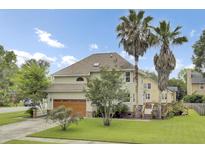 Charming two-story home with an attached garage and lush, green lawn at 16 Oatly Cir, Charleston, SC 29414