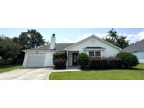 Charming single-story home features a well-maintained lawn, lovely front bushes, and an attached garage at 1705 Falcon Cove Ln, Hanahan, SC 29410