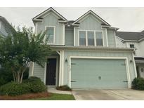 Charming two-story home with light-blue siding, a two-car garage, and a well-manicured front yard at 2208 Primus Rd, Mount Pleasant, SC 29466