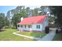 Charming one-story home with a red roof, covered porch, and well-manicured lawn at 236 Chamblee Rd, Walterboro, SC 29488