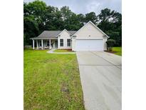 Charming single-story home with a well-manicured lawn and covered front porch at 2844 Curran Pl, Mount Pleasant, SC 29466
