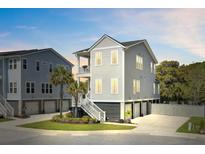 Beautiful two-story home featuring light gray siding, a balcony, landscaped yard, and convenient garage parking at 2928 Tranquility Rd, Mount Pleasant, SC 29466