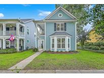 Charming two-story home featuring a quaint front porch and a neatly manicured lawn at 3152 Riverine, Charleston, SC 29414