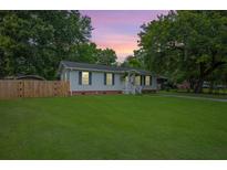 Charming single-story home features a well-maintained lawn, privacy fence, and inviting front porch at 401 Amy Dr, Goose Creek, SC 29445