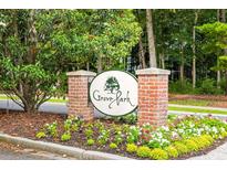 Grove Park entrance sign with brick pillars, manicured flower beds, and lush trees enhancing the welcoming curb appeal at 401 S Elgin Ct # 401, Charleston, SC 29414
