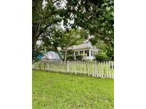 Charming home with a welcoming picket fence and lush greenery provides cozy curb appeal at 608 Dolphin Dr, Summerville, SC 29485