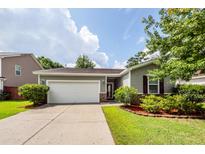 Charming single-story home featuring a two-car garage and beautiful landscaping at 611 Grassy Hill Rd, Summerville, SC 29483