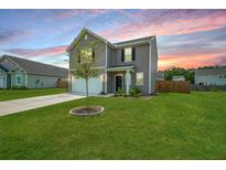 Beautiful two-story home featuring a well-manicured lawn and attached two-car garage at 716 Mcroy St, Moncks Corner, SC 29461