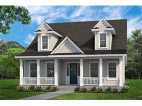 Charming home with a covered porch, white columns, dormer windows, and a well-manicured lawn at 100 E Carolina Ave, Summerville, SC 29483