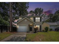 Inviting two-story home with a well-manicured lawn, attached garage, and classic curb appeal at 110 Yorkshire Dr, Summerville, SC 29483