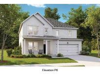 Charming two-story home with a beautifully landscaped yard, inviting front porch, and attached two car garage at 114 Orchard Blossom Ln, Summerville, SC 29485