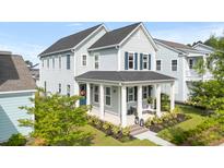 Charming two-story home with a welcoming front porch and beautifully landscaped yard at 115 Winding Branch Dr, Summerville, SC 29486