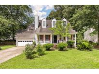 Charming two-story home with red shutters and a landscaped front yard and an attached two car garage at 117 Berringer Dr, Goose Creek, SC 29445
