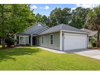 Charming single-story home with a well-manicured lawn, gray siding, and an attached two-car garage at 1420 Wellesley Cir, Mount Pleasant, SC 29466