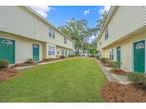 Charming two-story townhome featuring well-maintained lawn and green doors at 1423 Ashley River Rd # 3A, Charleston, SC 29407