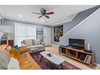 Bright living room with comfortable seating, stylish decor, and modern ceiling fan at 1713 Boone Hall Dr # 1082, Charleston, SC 29407
