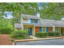Charming two-story home with brick accents, blue shutters, and a well-maintained, lush landscaped yard at 18 Indigo Ln, Goose Creek, SC 29445
