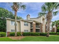 Well-maintained building with brick accents, tidy landscaping, and mature palm trees at 2011 N Highway 17 # 1400A, Mount Pleasant, SC 29466