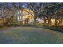 Stunning three-story home with double balconies and a lush landscaped lawn at 2206 Weepoolow Trl, Charleston, SC 29407